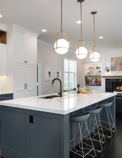 A kitchen with a large island and bar stools.