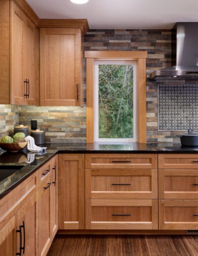 A kitchen with wood cabinets and granite counter tops.