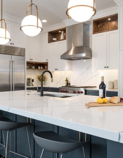 A kitchen with a large island and stools.