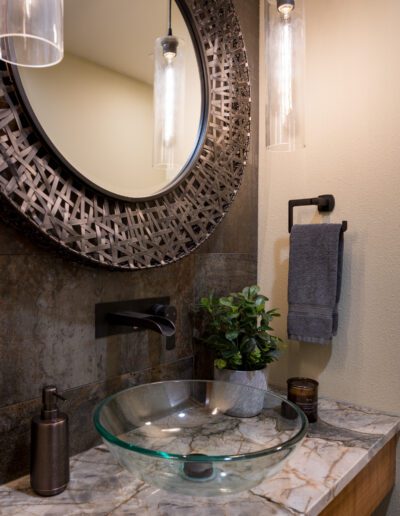 A bathroom with a mirror and a sink.