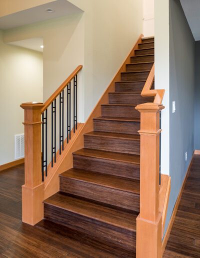 A staircase with wood treads and railings in a home.