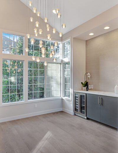 A kitchen with a refrigerator and a sink.