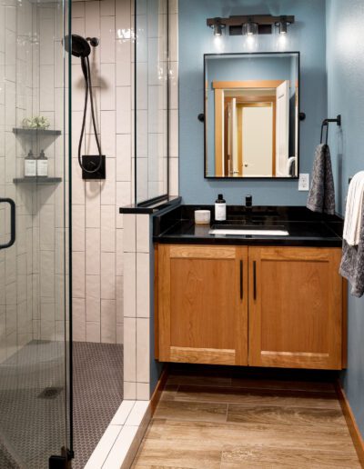 A bathroom with a glass shower stall.