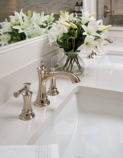 A white bathroom with two sinks and a mirror.