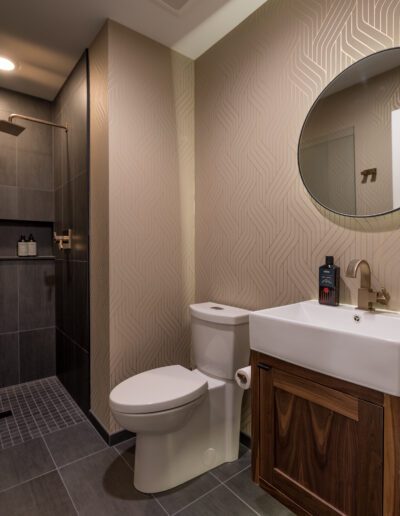 A bathroom with a toilet, sink, and shower.