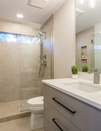 A bathroom with a sink, toilet and shower.