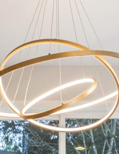 A circular light fixture hanging over a window.