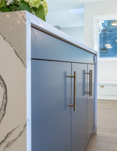 A kitchen with a marble counter top.