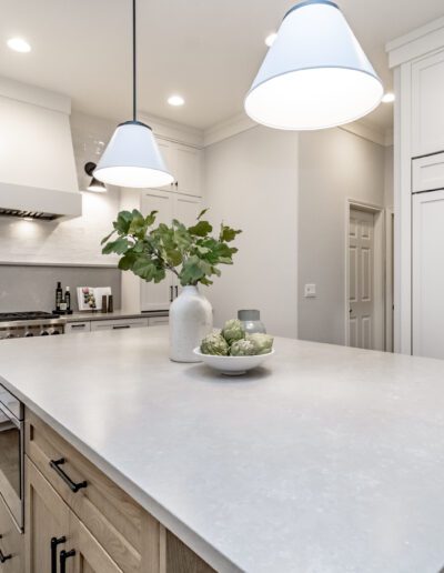 A kitchen with white cabinets and a center island.