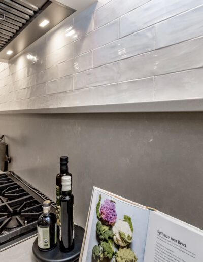 A kitchen with a stove and a book on it.