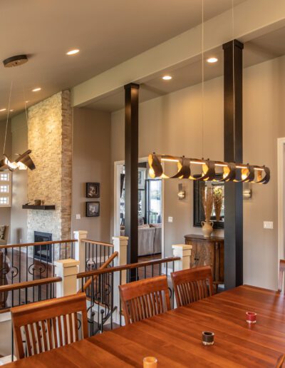 A dining room with a wooden table and chairs.