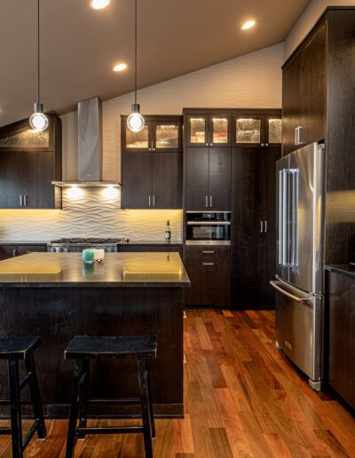 A kitchen with a large island and stools.