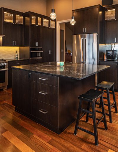 A kitchen with a center island and stools.