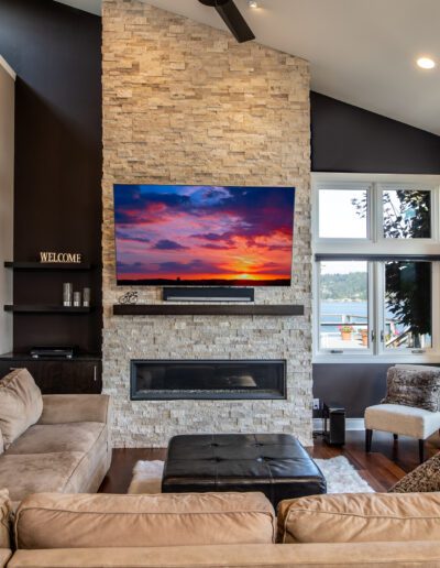 A living room with a fireplace and a flat screen tv.