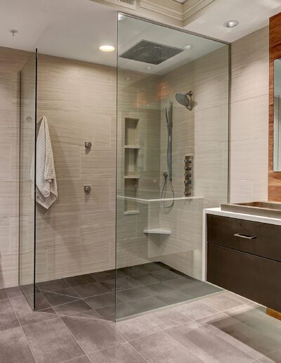 A modern bathroom with a glass shower stall.