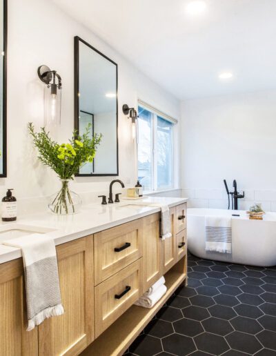 A black and white bathroom with a walk in shower.