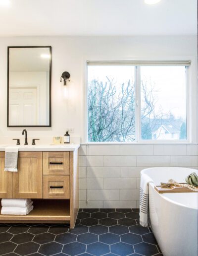 A modern bathroom with a large tub and sink.