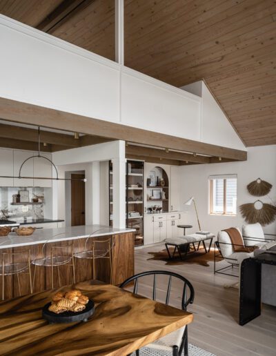 A modern kitchen and dining room with wooden ceilings.