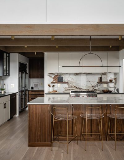 A kitchen with wooden beams and a center island.