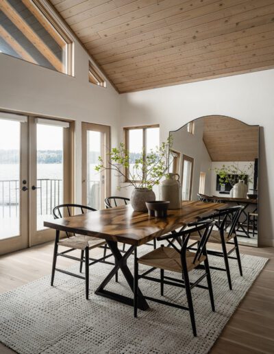 A dining room with a wooden table and chairs.