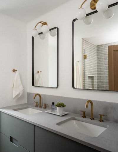 A bathroom with two sinks and two mirrors.