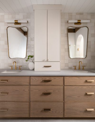 A bathroom with two sinks and a mirror.