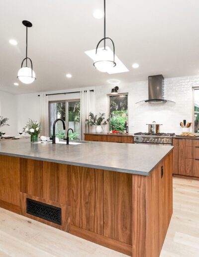 A modern kitchen with wood cabinets and a center island.