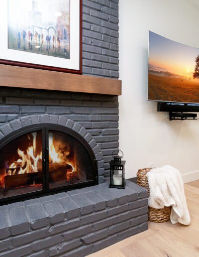 A fireplace in a living room with a tv above it.