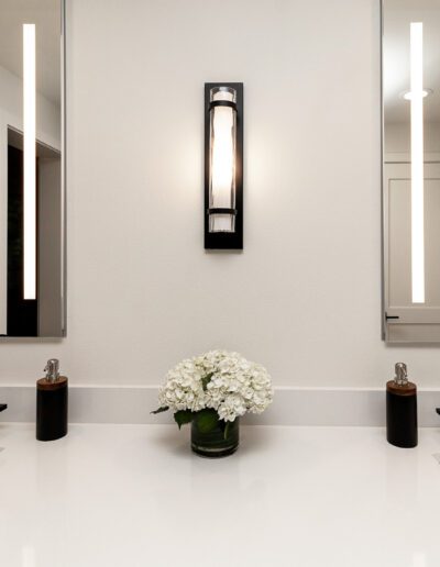 A bathroom with two sinks and a mirror.