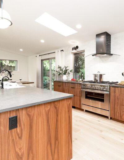 A modern kitchen with wood cabinets and stainless steel appliances.