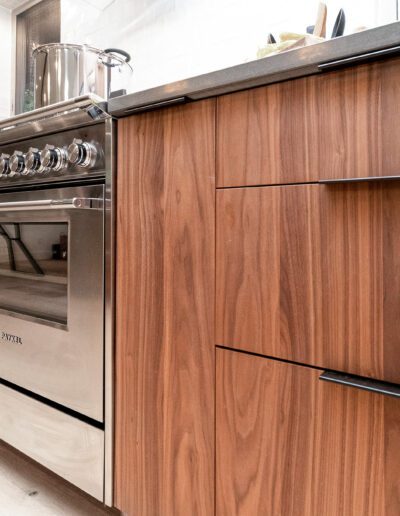 A modern kitchen with wooden cabinets and a stove.